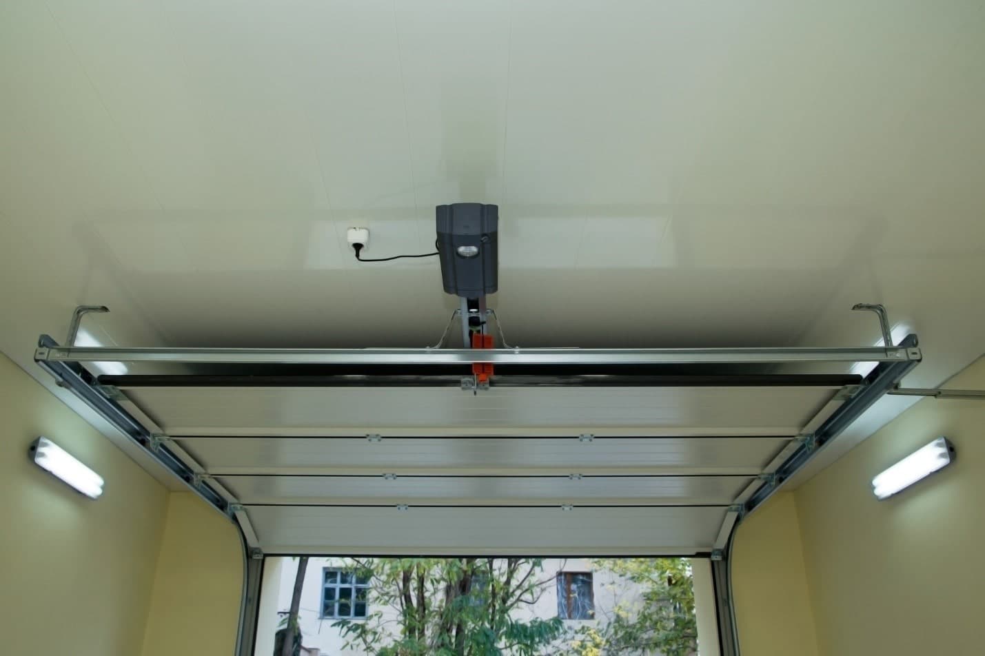 Homeowner troubleshooting a garage door that will not close in Calgary